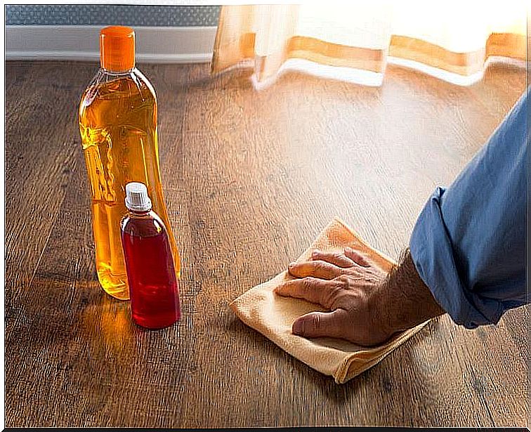 Person waxing wooden floor.