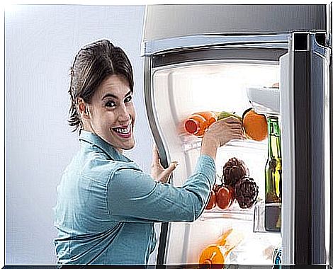 woman putting food in the fridge