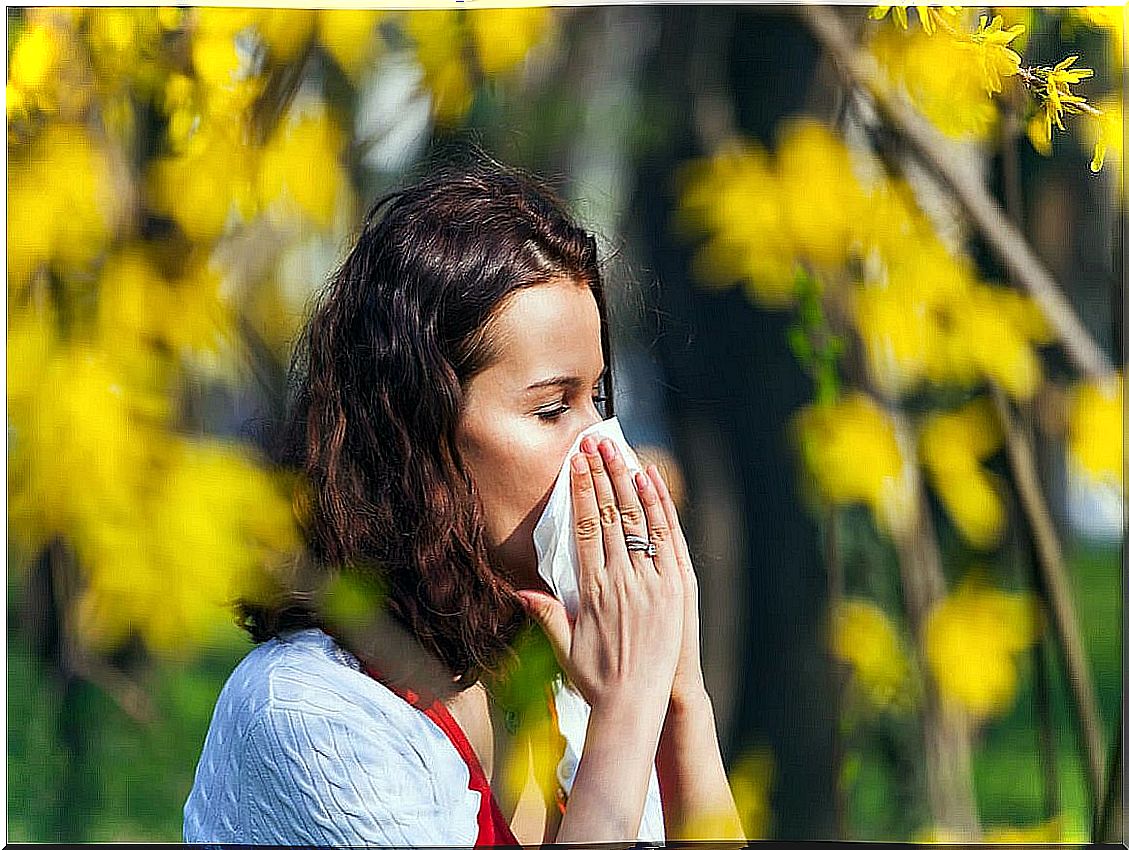 Woman with sneezing from allergy.