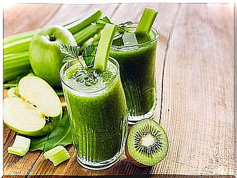 Green smoothie and vegetables: kiwi, apple and celery.