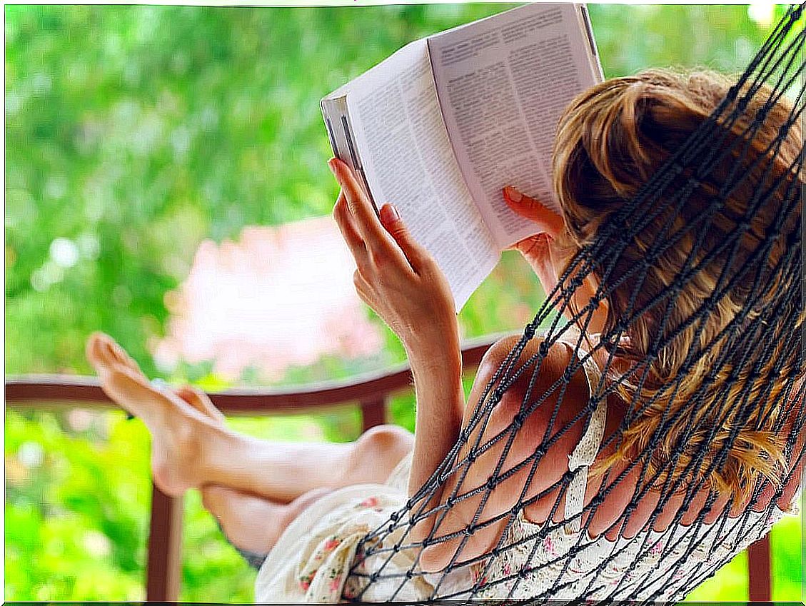 Woman reading a book lying down