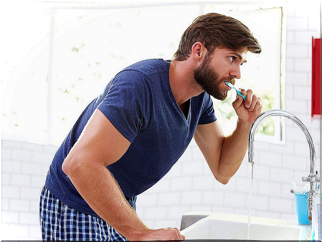 Man brushes his teeth.