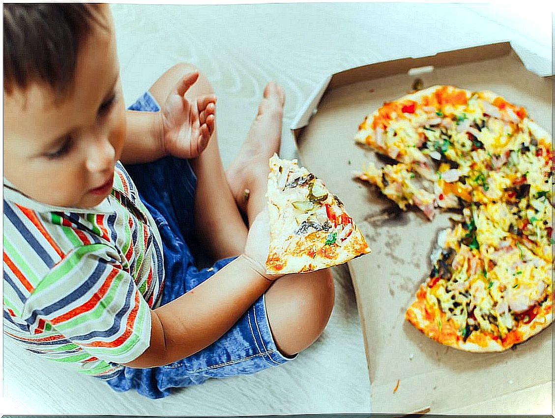 Boy eats pizza