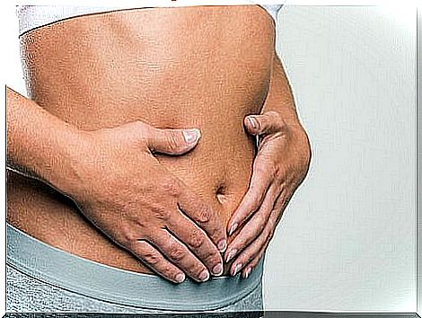 Woman with hands on belly